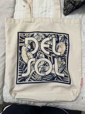 Del Sol color changing Cream Canvas Shoulder Tote with Navy Parrot Graphic